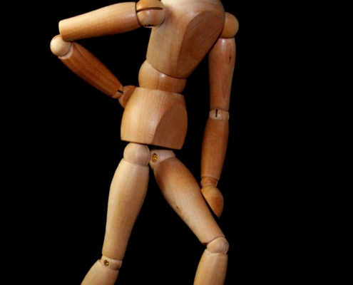wooden figure model with back pain