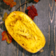 Overhead view of Spaghetti squash on a wooden background with squash seeds