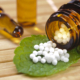 alternative medicine with homeopathic globules on leaf